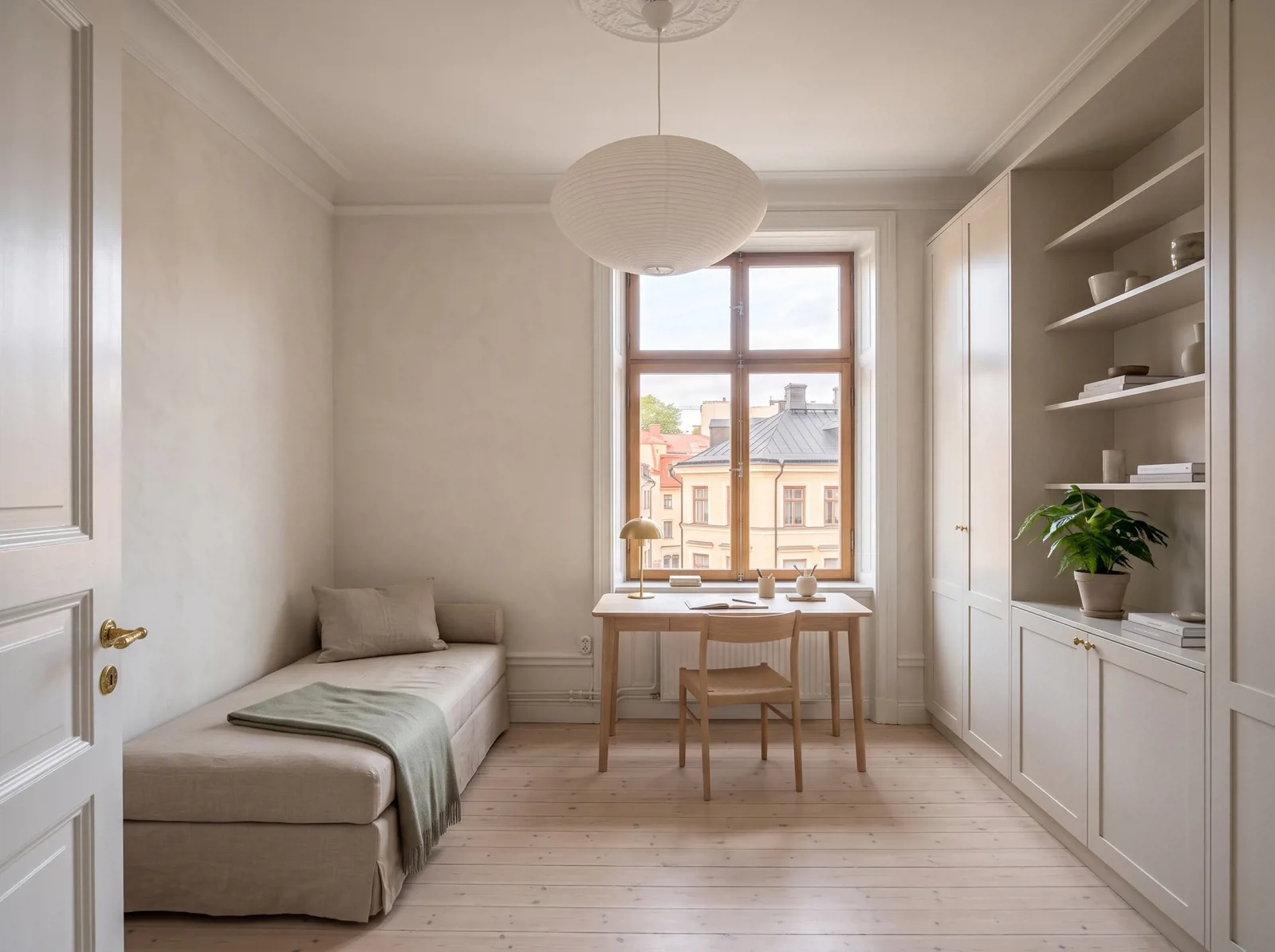 Compact room with a daybed, window-facing desk and full-height built-in storage